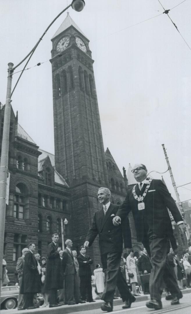 Marching Triumphantly from the old city hall to the new are Metro Chairman William Allen, left, and Mayor Givens, on their day of supreme satisfaction