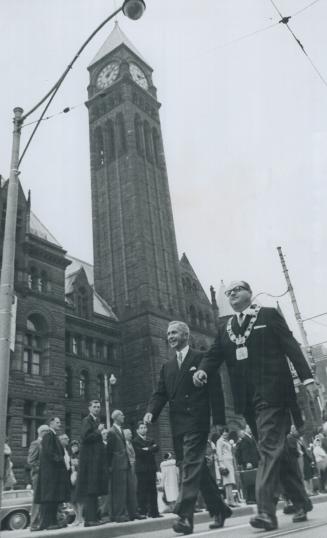 Marching Triumphantly from the old city hall to the new are Metro Chairman William Allen, left, and Mayor Givens, on their day of supreme satisfaction