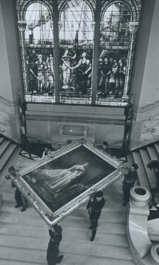 Would she be Amused?, Laboring under its weigh of 300 pounds, workmen carry an oil painting of Queen Victoria down the stairs of old City hall today