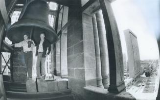 Last ding-dong: Maintenance men Manuel Machado, left, and George Thompson are dwarfed by a giant bell in the clock at old city hall