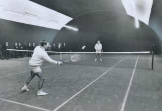 Tennis is a balloon, Club pro Jim Bentley (foreground) and Ken Sinclair play tennis in Swedish-designed air-supported dome at Toronto Cricket, Skating and Curling Club