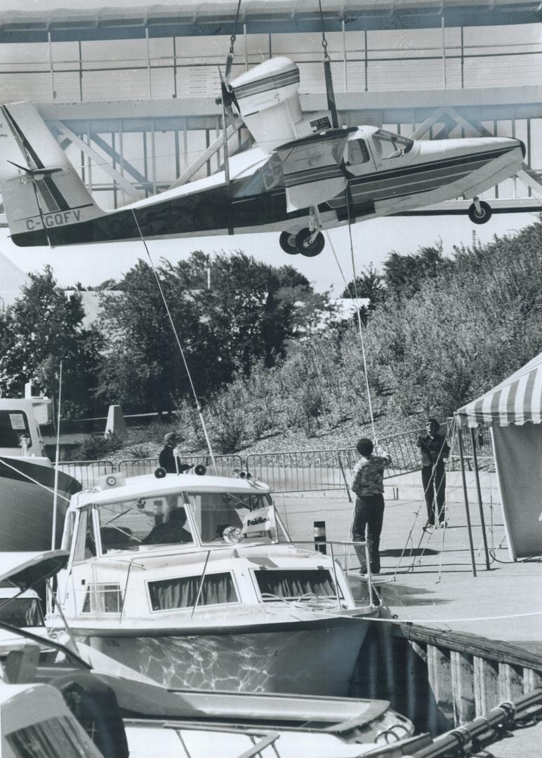 Fliers and floaters at boat show, Preparing for launching today of the sixth annual Dockside Floating Boat Show near Ontario Place, a $55,000 Lake Buc(...)