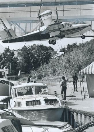 Fliers and floaters at boat show, Preparing for launching today of the sixth annual Dockside Floating Boat Show near Ontario Place, a $55,000 Lake Buc(...)
