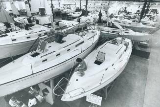 10 Acres of boats open today, Last-minute touches are given to some of the $20 million worth of boats, sails, engines and marine gadgetry at 20th annu(...)