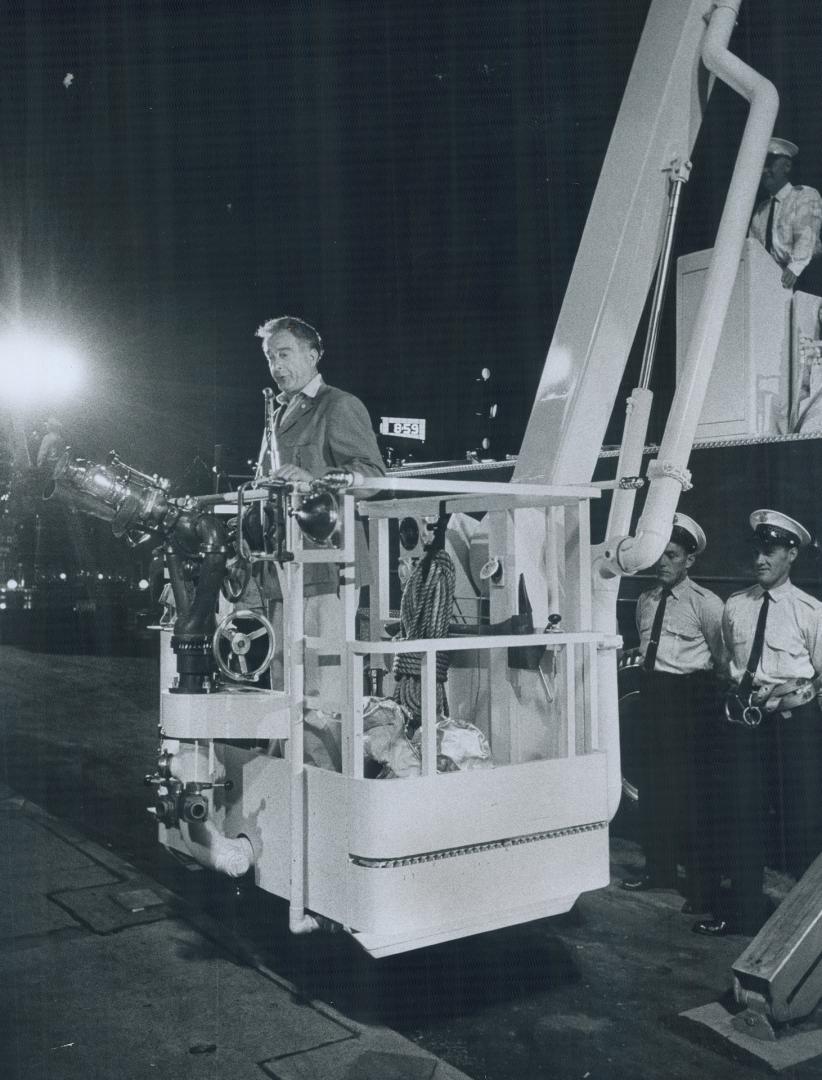 The funnyman, Getting in the mood for tonight's opening Grandstant show Victor Borge tries out huge asbestos suit and a mobile fire truck boom