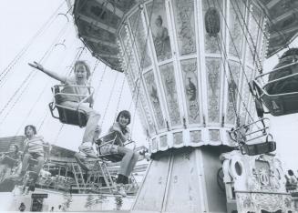 Children try out a high-flying Midway ride in special preview of the Canadian National Exhibition yesterday