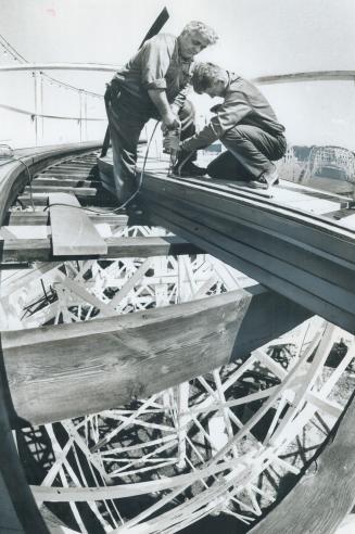 Rails for a roller coaster, Harvey Thompson (left) and Dennis Davis overhaul the roller coaster at the Canadian National Exhibition