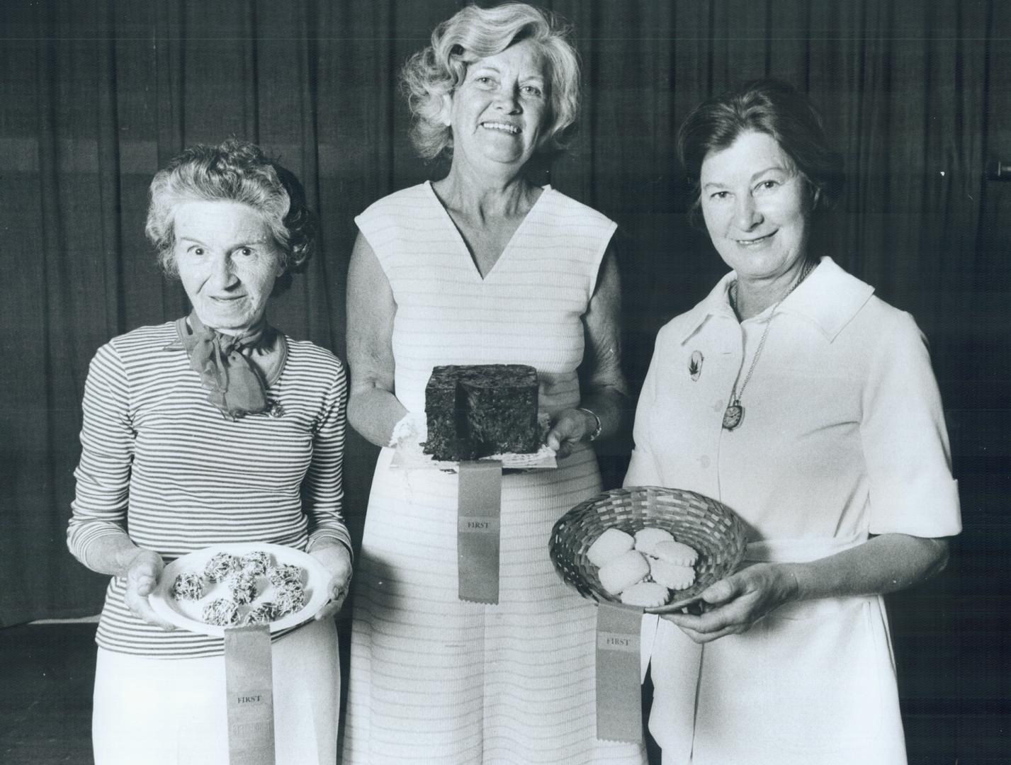 The winners in three categories at the Canadian National Exhibition baking contest yesterday proudly display their shortbread, fruitcake, and cookies.(...)
