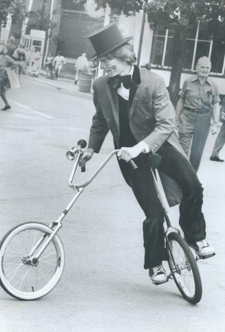 Wayward driver, Ed Hore, one of several clowns doing the rounds at the Ex, has found an ideal way to get around obstacles - he rides a cycle that will go in two directions at once