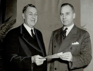 Controller Wadsworth (Left) With Commissioner Lascelles and Cheque, A cheque for $450 was handed to the Red Cross British Bomb Victims Fund by Finance(...)