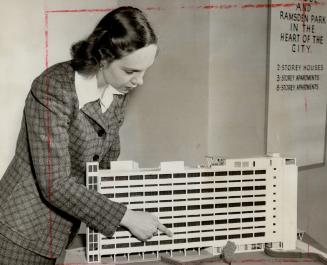 Model apartment house of tomorrow is examined by Miss Betty Schondelmeyer at the City for Tomorrow town planning display in Eaton's College Street store