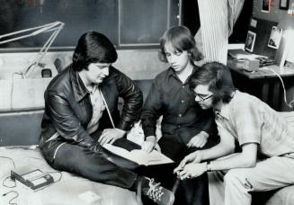In Rochdale College, Larry Nedelkoff, 20, David White, 12, and Bob Allen look at a book