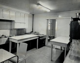 An example of the poor courtroom facilities to be found in West Metro, Canadian Legion hall kitchen serves as judge's chambers for the hearing of minor cases