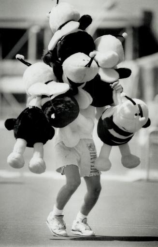 Gearing up for CNE, Mike Laidlaw, 17, struggles with stuffed critters yesterday at the CNE where midway folks are setting up game booths for opening d(...)
