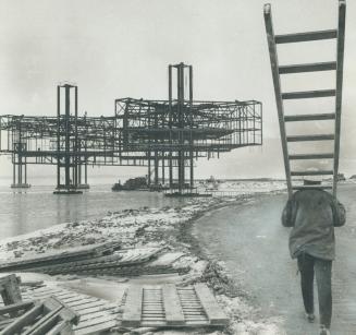 Ontario pavilion--A place to stand, Toting a ladder, a workman makes his way along the road to Ontario Place, the five-part pavilion the government is(...)