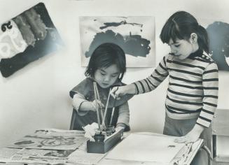 Young children, some of whom cannot speak English, paint together in the kindergarten of a Portuguese information centre on Bathurst St., where immigr(...)