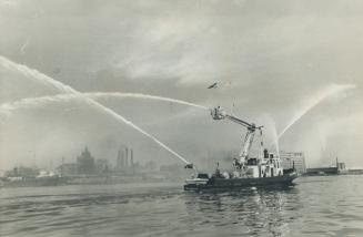 Enter William Lyon Mackenzie, Toronto's spanking new $600,000 fireboat triumphantly enters harbor today jetting streams of water to the wail of sirens and blare of fog horns