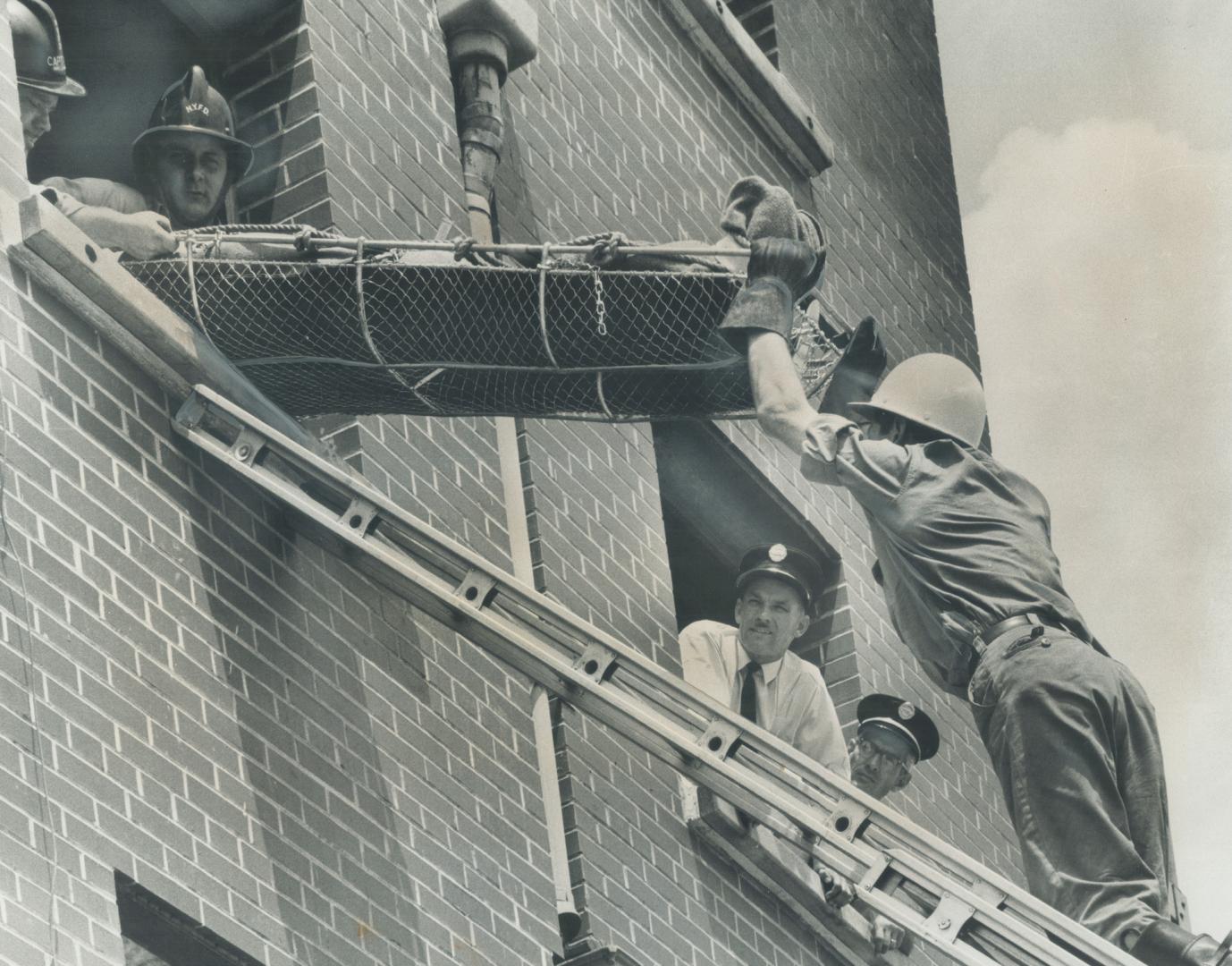 Fire Captain Jack Wright (bottom, left) watches rescue training operation, some recruits do panic when confronted by fire at its hottest and deadliest, he says