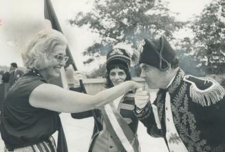 Proving the French are always gallant, even during a revolution, Napoleon Jerry Palmer Kisses the hand of Marcelle Campana at yesterday's Bastille Day(...)