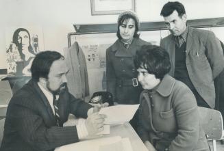 Interpreter Lewis Aguiar helps Zulmira Cabrita and Jose Pera, both standing, and Victoria Guerreiro, at the Portuguese Centre. Portuguese agencies are(...)