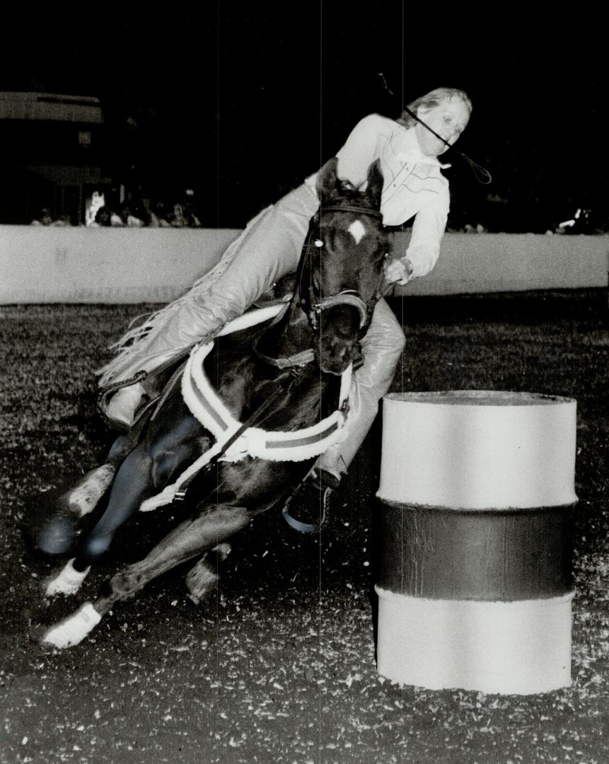Roll past the barrel: That's what Virginnia Reynolds is trying to do in the ladies' barrel race at the annual CNE Horse Show