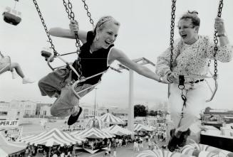 Hanging out at the ex, Jennifer Bertucci, 15, left, grips the hand of Lacey Belanger, 15, as they take a spin on the Wave Swinger ride high above the (...)
