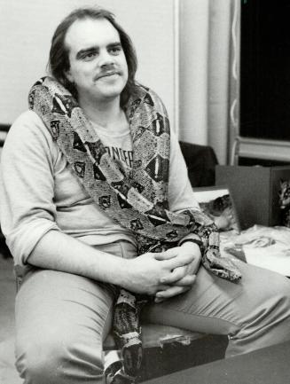 Snakes alive!, John Bueglas is all wrapped up by his 10-foot boa Constrictor