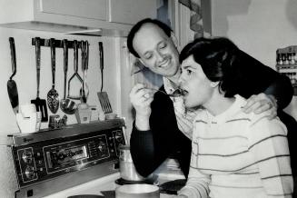 Maltese-born Richard Cumbo, an information clerk for the Rent Review Board, serves wife Madlene some inbuljuta, a Maltese hot toddy made from chestnuts