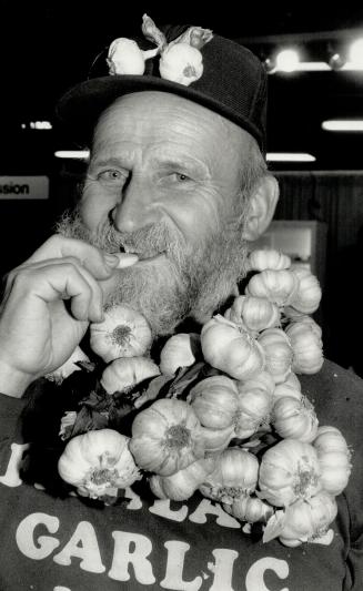 Garlic lover: Ted Maczka, known as the Fish Lake Garlic Man, bites into a bud of his favorite food in the Ontario Foodland section of the Royal Agricultural Winter Fair