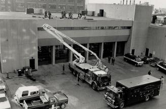 Search for cause: Officials are trying to find out how four firefighters plunged two storeys from the cherry picker on this firetruck to the roof of a fire hall