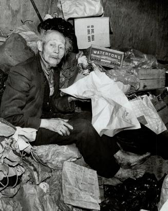 Sitting in his parlor, 84-year-old Chinese immigrant Jen Hum prepares to hunt for belongings before being taken to Toronto General Hospital last night(...)