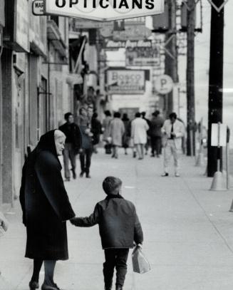 Dressed in Black, an Italian grandmother walks along St