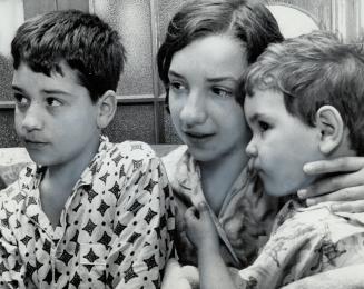 Victims of tear gas bomb, the three children of Italian grocer Joseph Parravano, from left, Vincent, 9, Franka, 12, and Tina, 3, sit in neighbor' home(...)