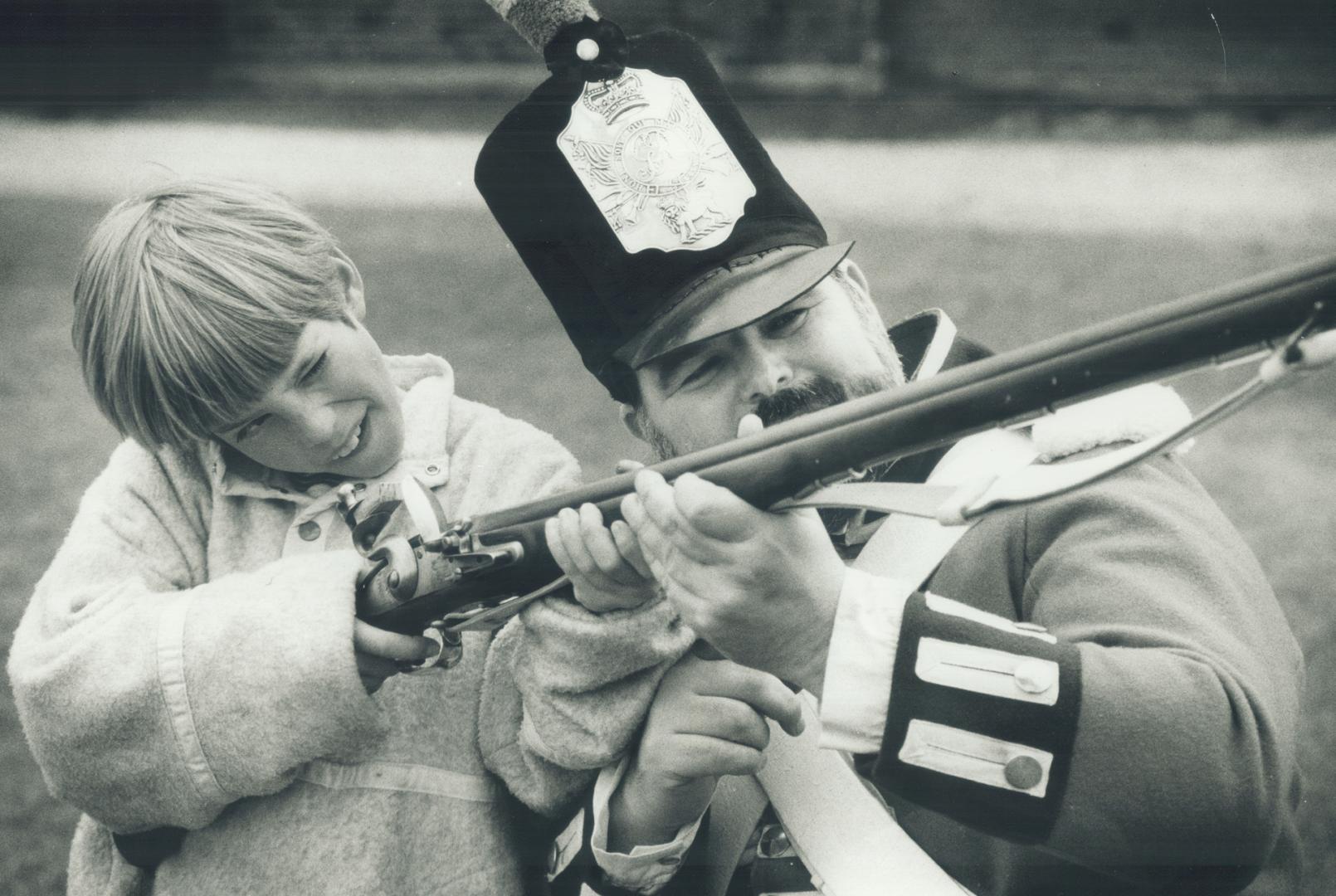 A helping hand. Zorro Zonnekeyn gets a private lesson in handling a Brown Bess Musket from Private Malcolm Wootton at Toronto's Historic Fort York yes(...)