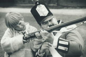 A helping hand. Zorro Zonnekeyn gets a private lesson in handling a Brown Bess Musket from Private Malcolm Wootton at Toronto's Historic Fort York yes(...)