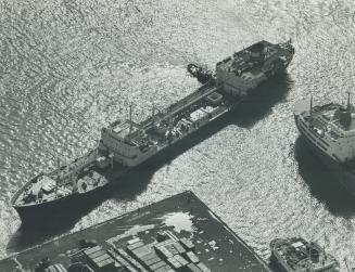 Image shows an aerial view of a few boats on the lake.