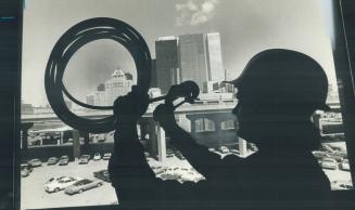Image shows a worker in the process of plumbing and fixing the heating system with the high-ris…