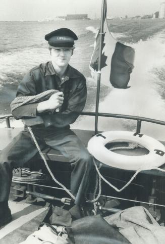 Image shows a seaman working on the police boat.