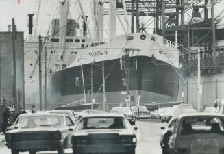 Image shows a huge cargo ship docked.