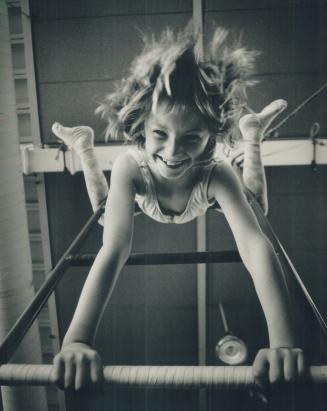 A star is born. Seven-year-old Katie Whitiker looks like a pro as she hangs from a ladder at Harbourfront walking a tight rope or just clowning around in the March break program