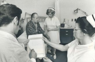 A doctor and nurses attend a patient in a three-bed room at Lockwood Clinic, a 50-year-old hospital on Bloor St
