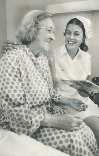 Candy striper Lily Cugliari chats with patient Stella Brown in Toronto Western Hospital