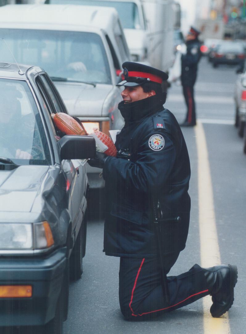 Const. John Altilia sells salami for the Herbie Fund