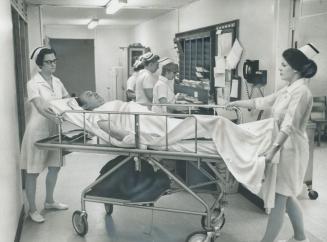 In the emergency ward, the most hectic area in the over-burdened 246-bed Northwestern General Hospital, head nurse Jane Conaghan (left) and nurse Pat (...)