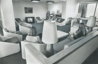 Modern, comfortable furniture sets a relaxing mood in the community areas like this TV room in the Queen St