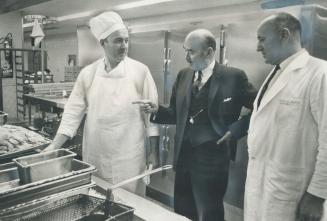 A thorough physical checkup is given to the kitchen of Wellesley Hospital by Dr. William Taylor (centre), director of the Canadian Council on Hospital(...)