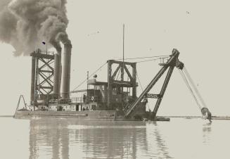Image shows a workboat in action.
