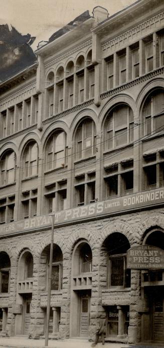 Three-story brick and stone building with arched windows displaying the sign Bryant Press Limit…