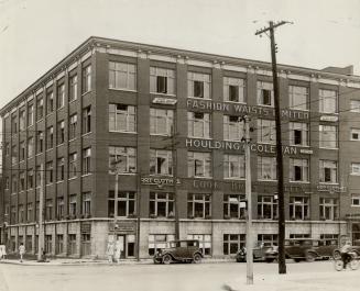 Exterior view of five-storey brick building. The following company names are mounted to wall be ...