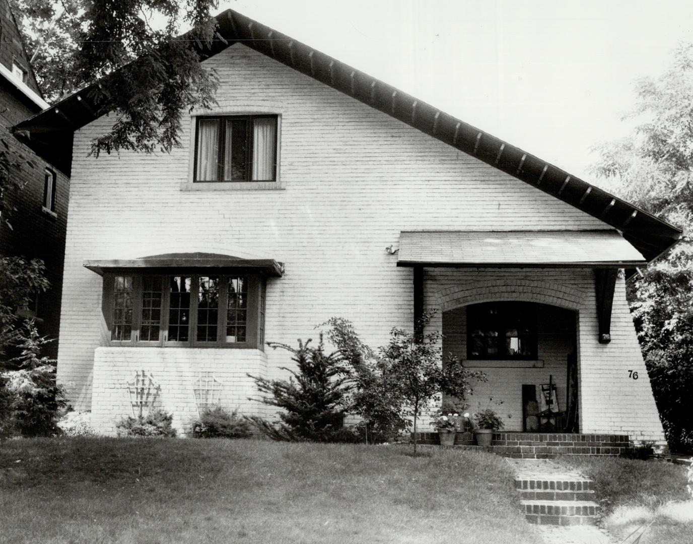 Image shows the front view of a two storey residential house.